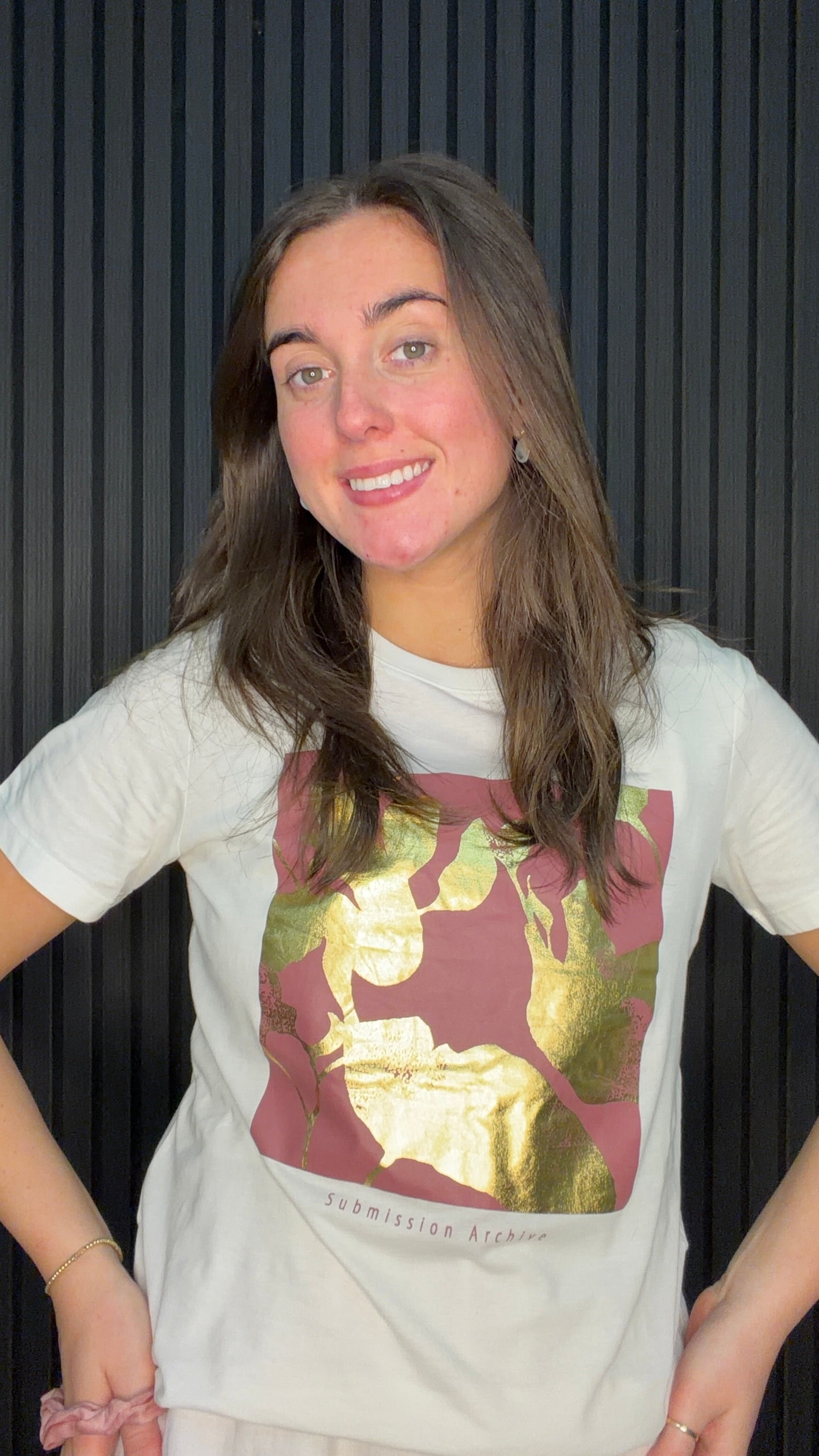 Model wearing the Lima Floral Graphic T-Shirt in Cloud Dancer with a bold floral print and metallic gold foil detailing.