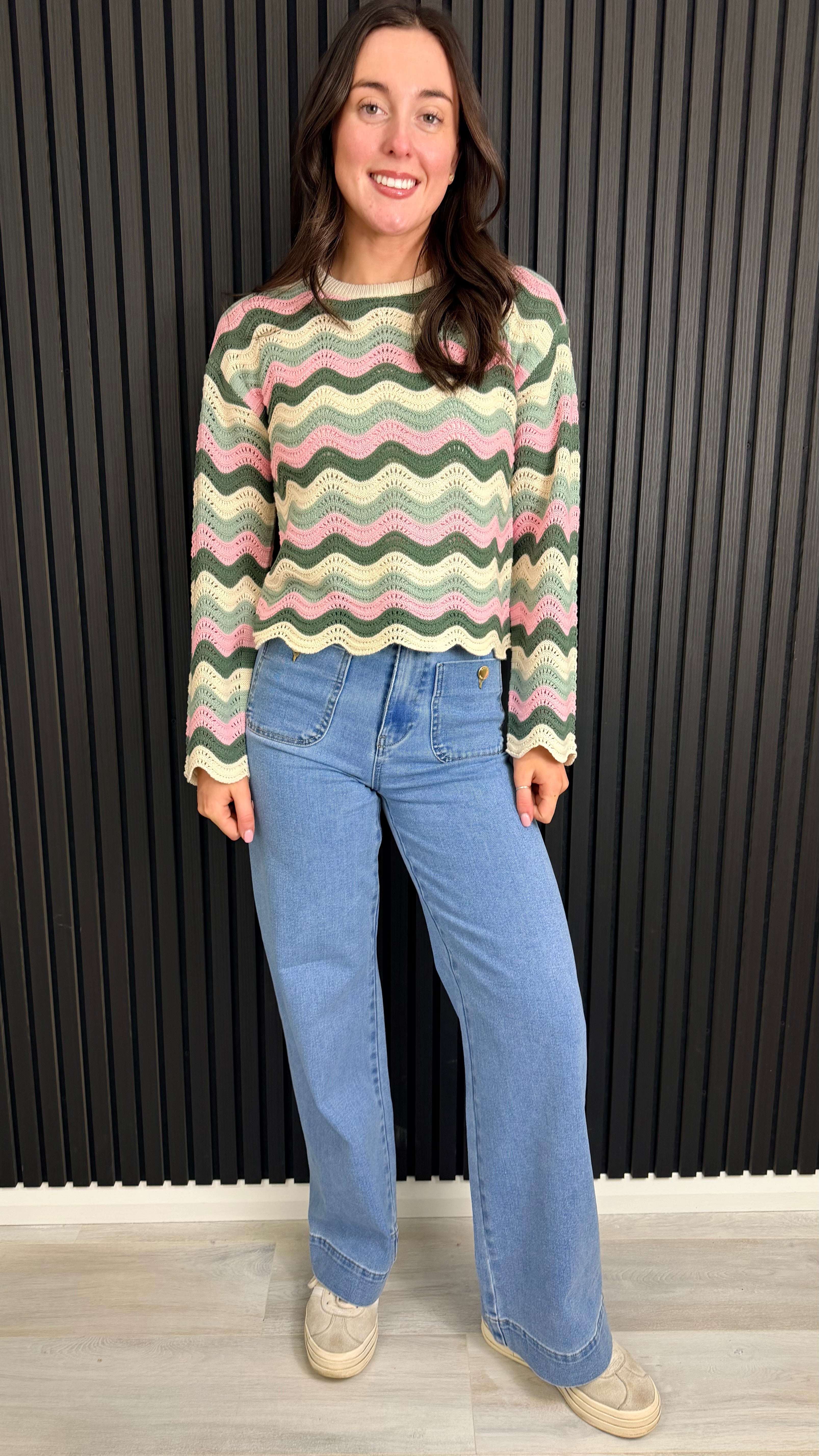 Full length of pink zigzag knit jumper on model