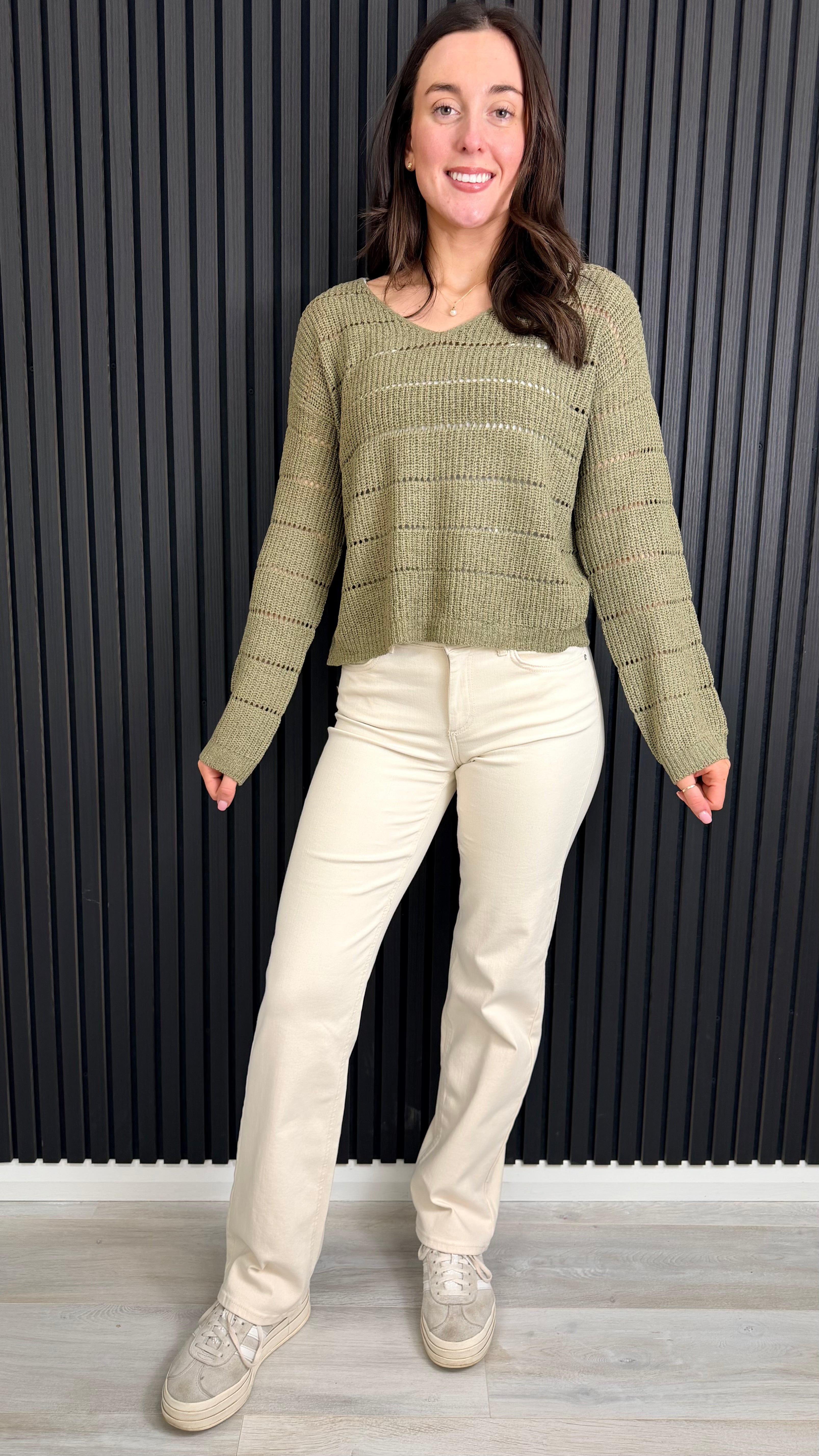 Full length view of ecru straight-leg jeans styled with a knit jumper.