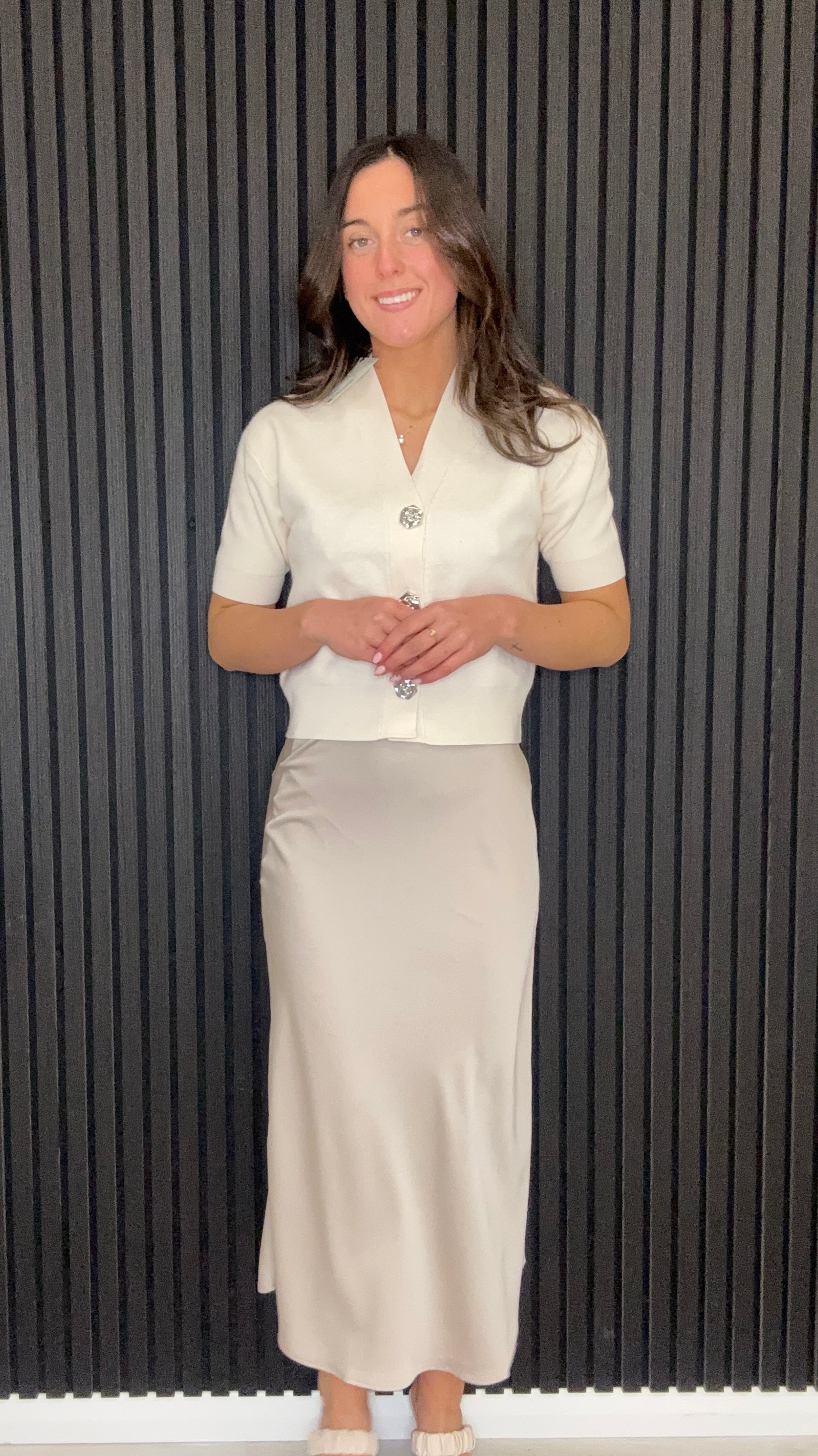 Champagne satin midi slip skirt styled with knit cardigan