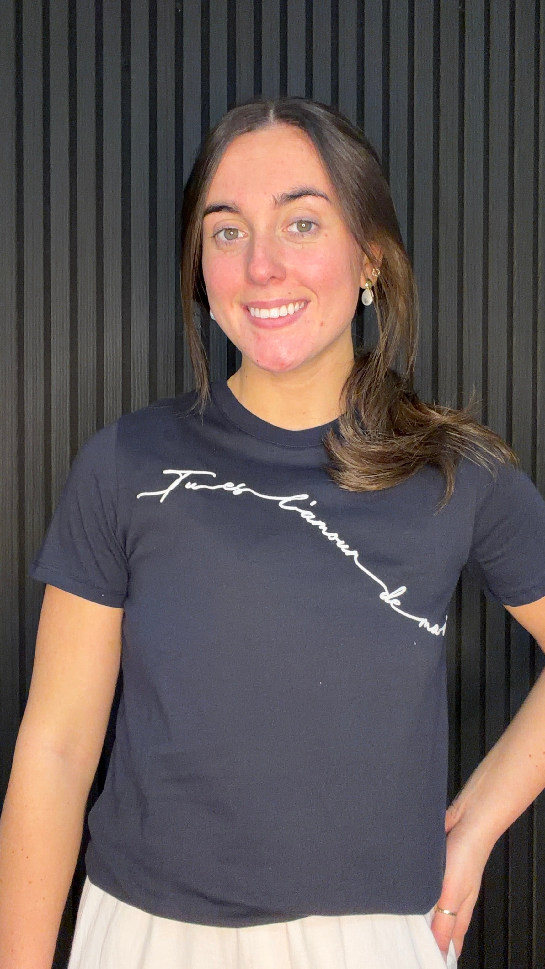 Model wearing the Love T-Shirt in Navy with a white script slogan design.