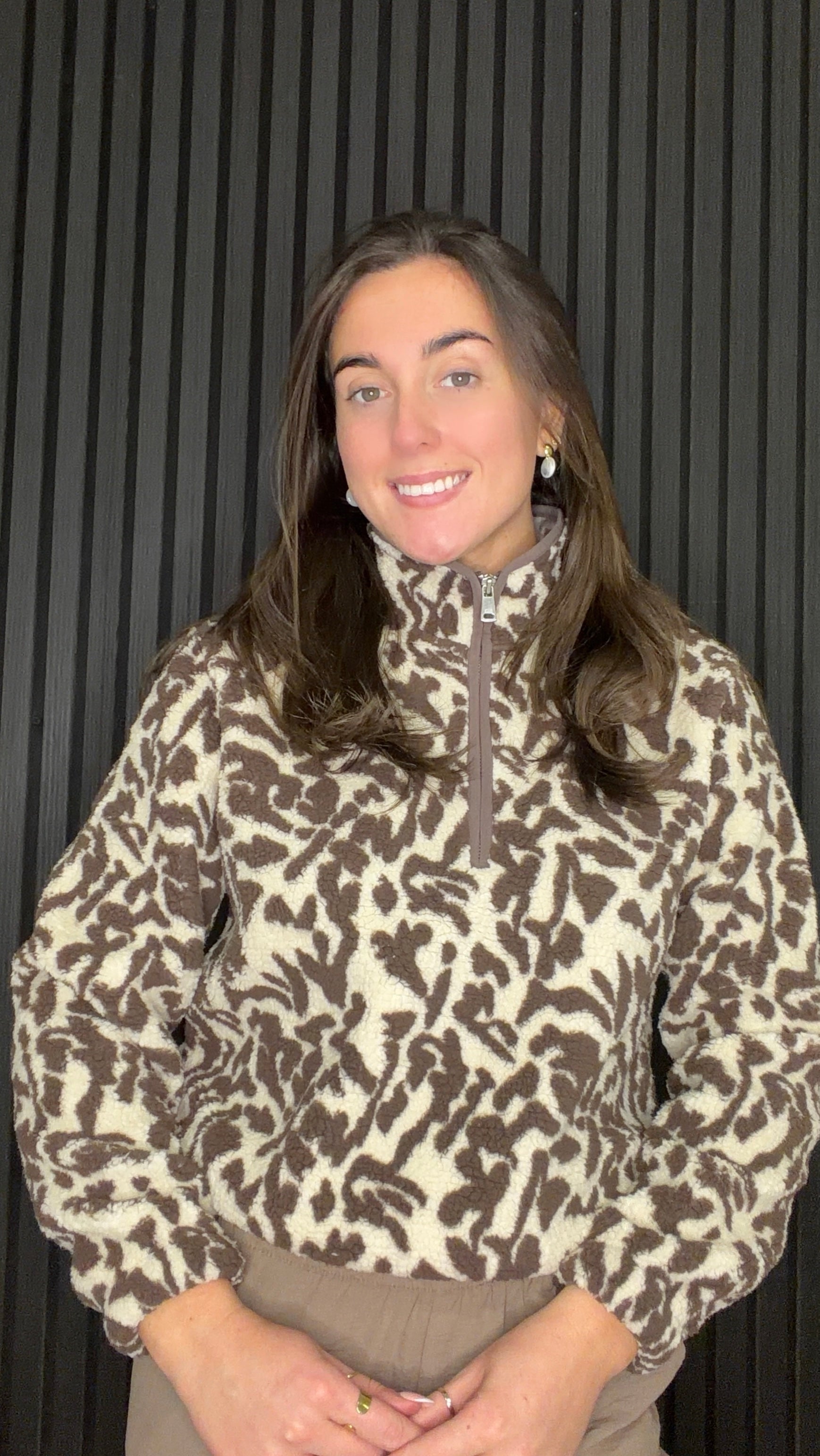 Model wearing the Dallas Printed Fleece Pullover in Bracken with a botanical print and half zip high neck.