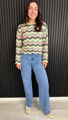 Full length of pink zigzag knit jumper on model