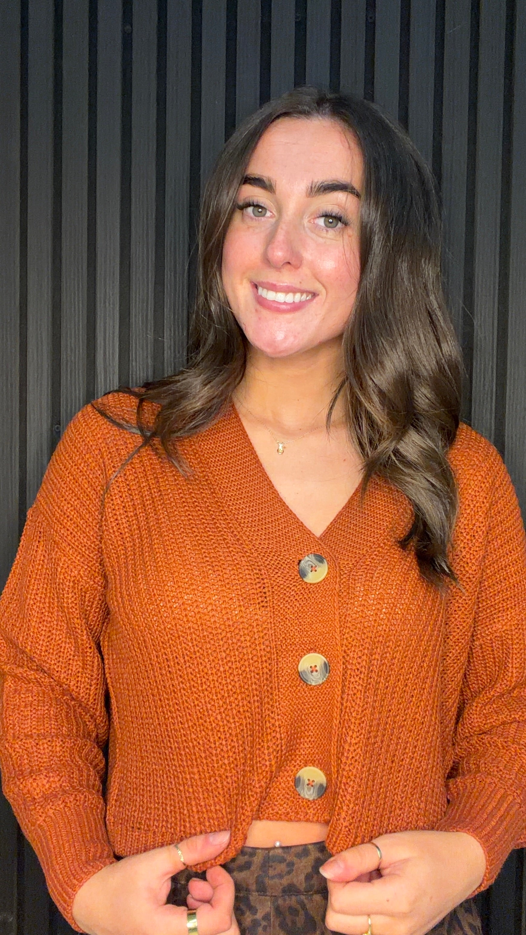 Model wearing the Carol Knitted Cardigan in Picante with a V-neck, button fastening and relaxed fit.