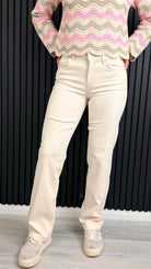 Front view of ecru straight-leg jeans styled with a knit jumper.