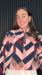 Model wearing the Dallas Printed Fleece Pullover in Fig with a geometric print and half zip high neck.