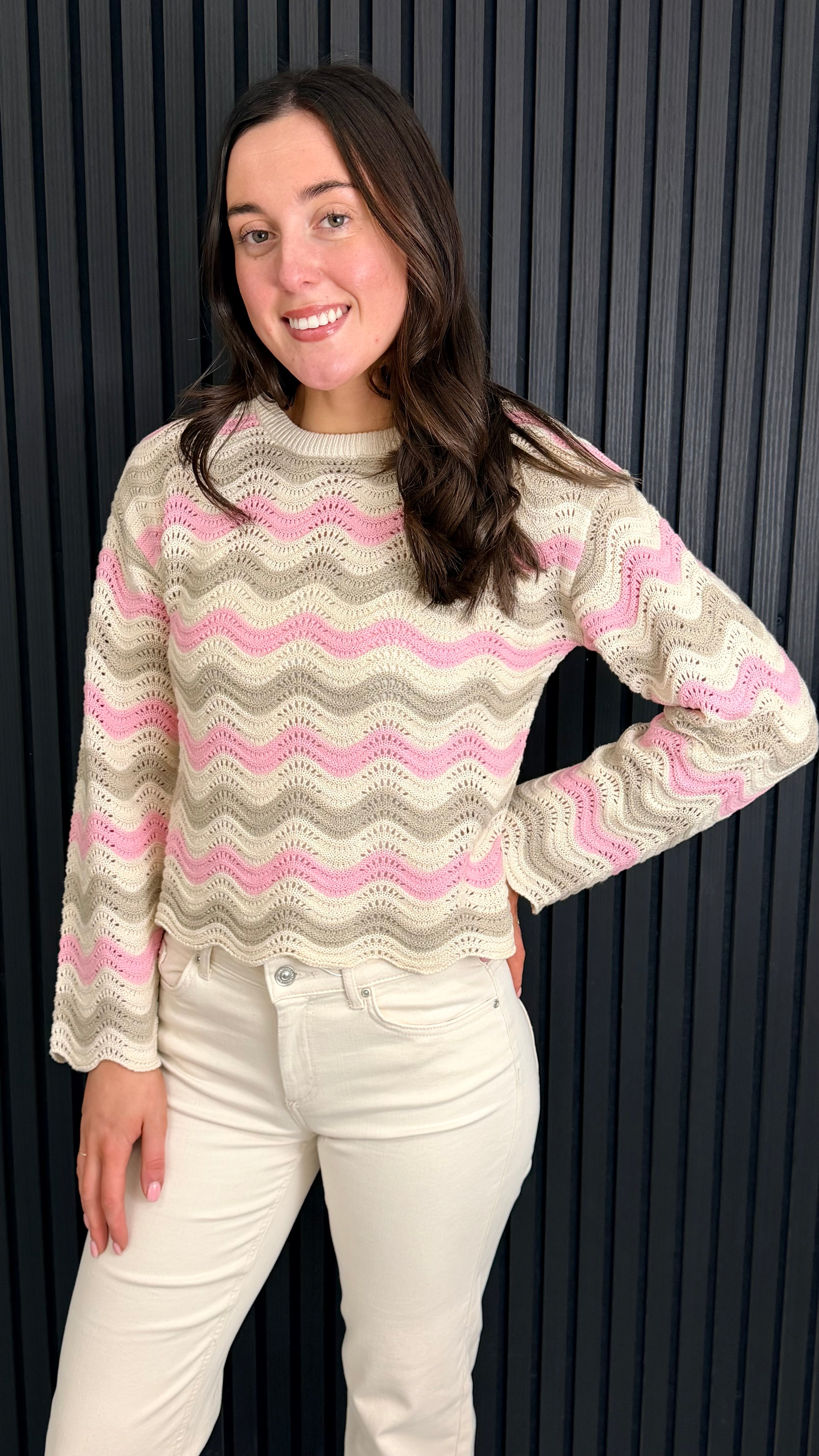 Close view of pastel zigzag knit jumper on model