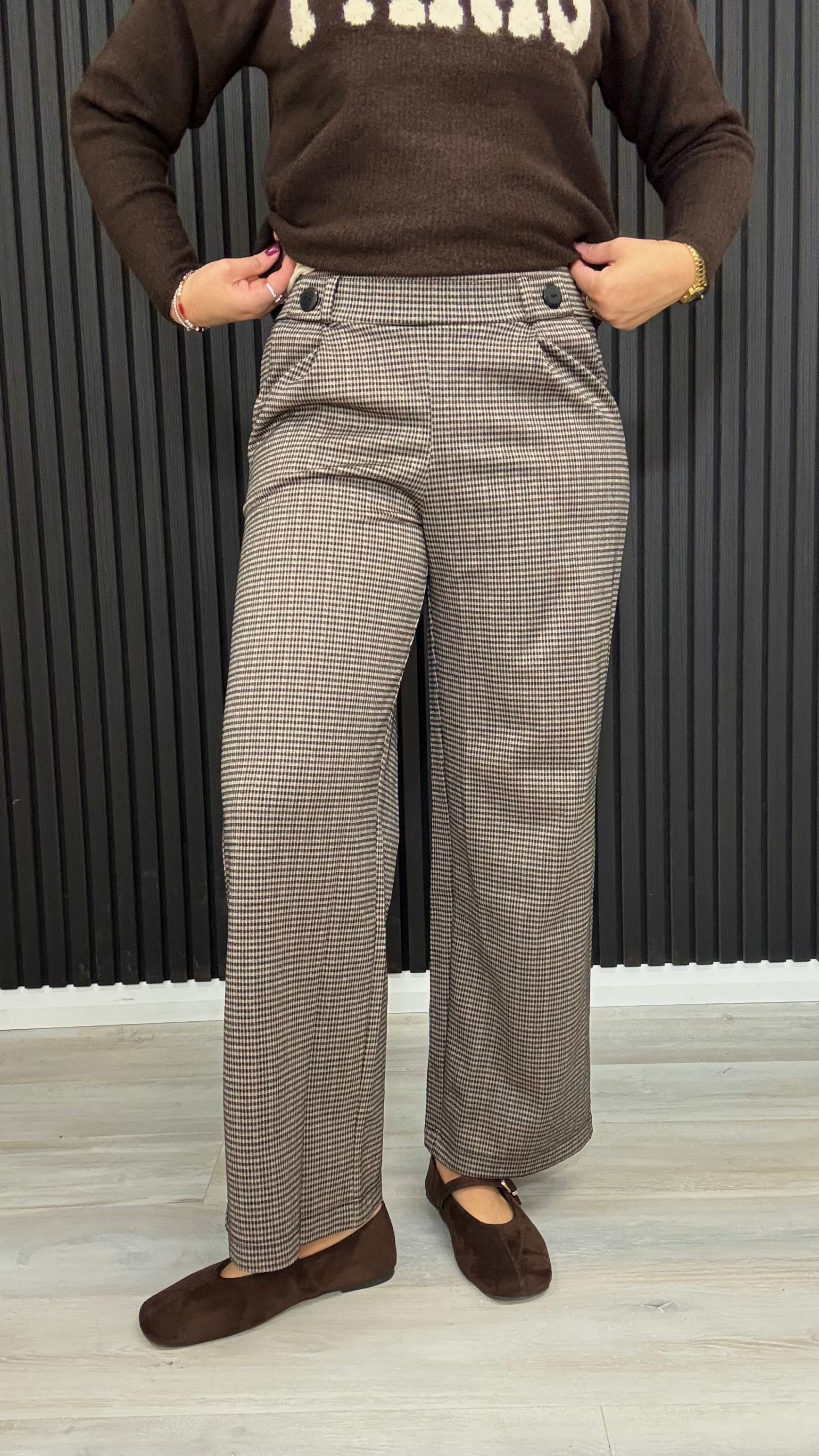 Mia brown check wide leg trousers with button waistband detail.